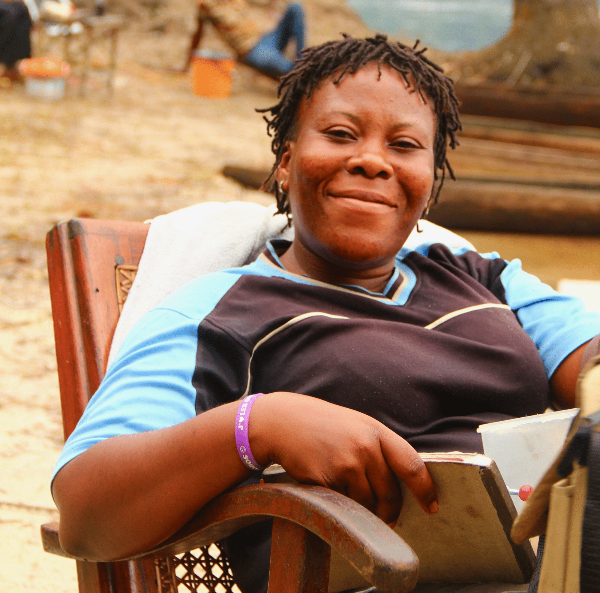 Suzy Kwetuenda (female) sits smiling