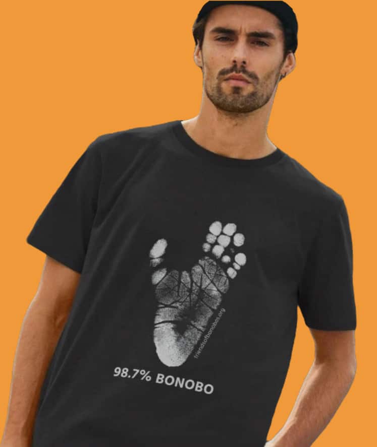 A man with a beard modeling a t-shirt that has a bonobo handprint and reads 98.7% bonobo.