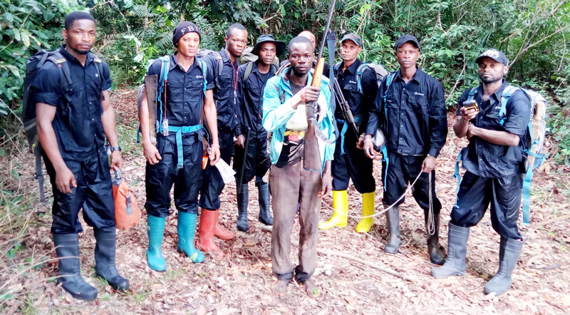 Ekolo ya Bonobo guards wearing navy blue uniforms and gumboots standing in a horizontal line