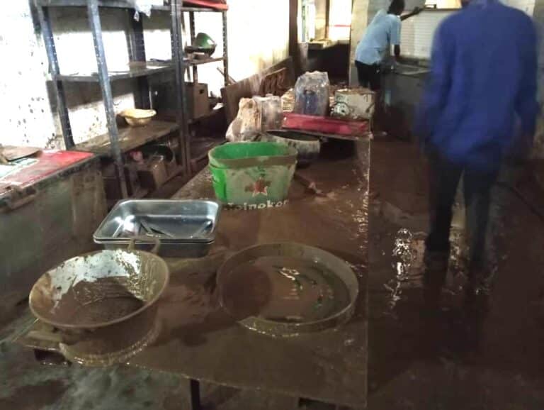 Interior of building covered in mud after flood.